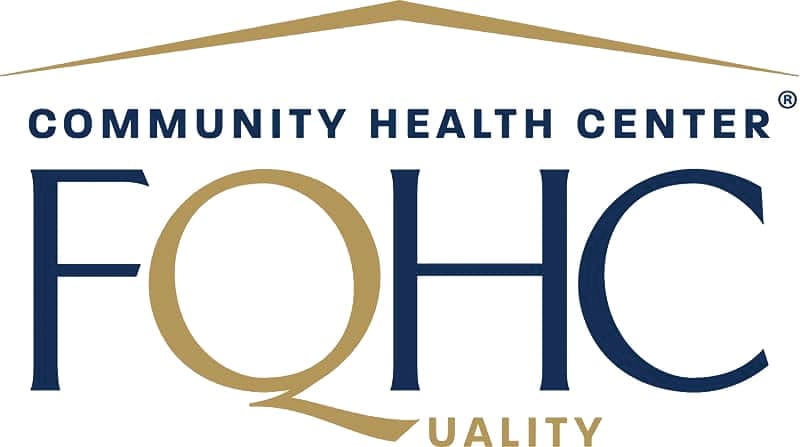 Logo for Community Health Center FQHC. The letters FQHC are large; Q is gold and overlaps with the word QUALITY below. A gold roof shape sits above the text.