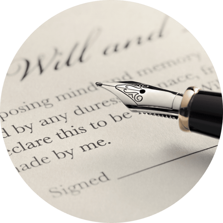 A close-up of a fountain pen resting on a legal document titled Will and Testament, with the word Signed visible at the bottom.