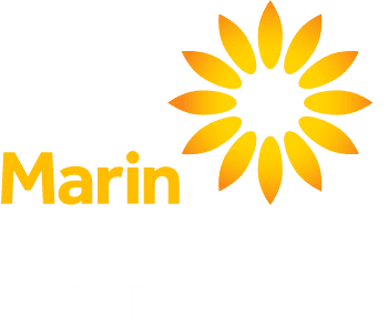 Logo for Marin Community Clinics featuring a stylized yellow and orange sunburst with the words Marin Community Clinics below, where Marin is in bold orange and Community Clinics is in light gray.