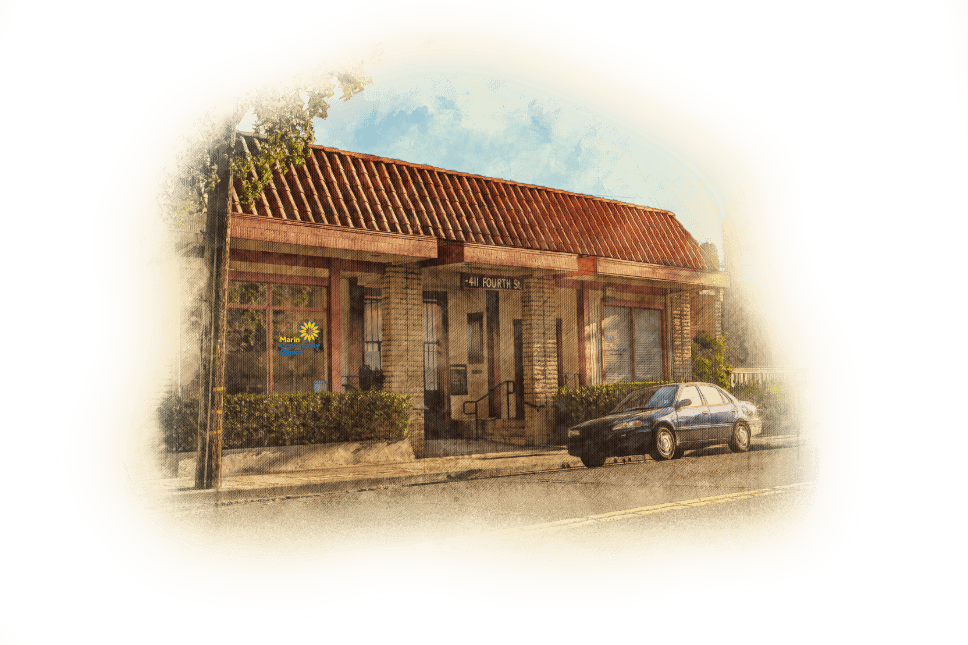 A small brick building with a tile roof sits on a quiet street. A blue car is parked outside, and a tree stands nearby. The building’s windows have signs, and the address 44 ROUTE 3 is visible above the entrance.