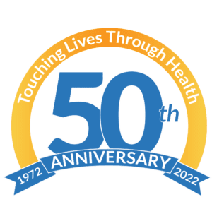A logo with the text “Touching Lives Through Health” above a large blue “50th,” and a ribbon below reading “ANNIVERSARY 1972 – 2022.”.