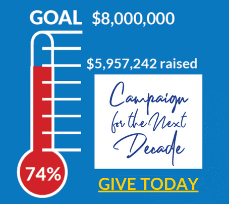 A fundraising thermometer shows 74% filled, with $5,957,242 raised toward an $8,000,000 goal. Text reads “Campaign for the Next Decade” and “GIVE TODAY” in bold yellow letters.