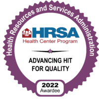 A circular purple badge labeled “Health Resources and Services Administration,” with “HRSA Health Center Program” in the center, “Advancing HIT for Quality,” and “2022 Awardee” at the bottom.