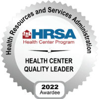Silver badge with the Health Resources and Services Administration (HRSA) logo, reading Health Center Program, Health Center Quality Leader, 2022 Awardee.